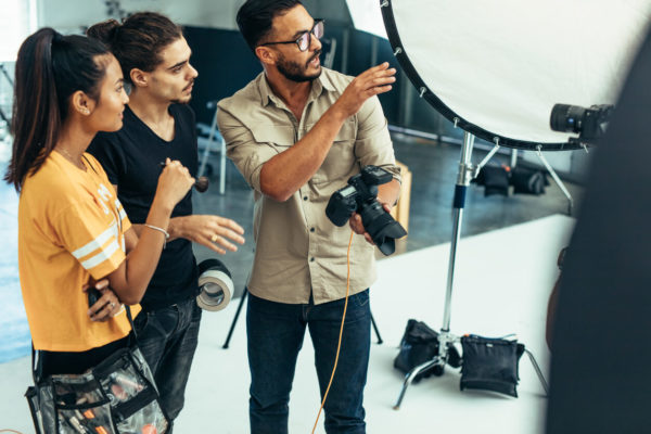 Two-People-Looking-At-Person-With-Camera