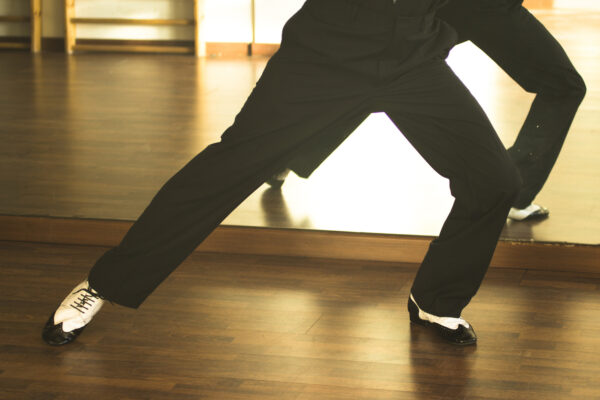 Ballroom dance male dancer and teacher in studio school dancing in rehearsal.